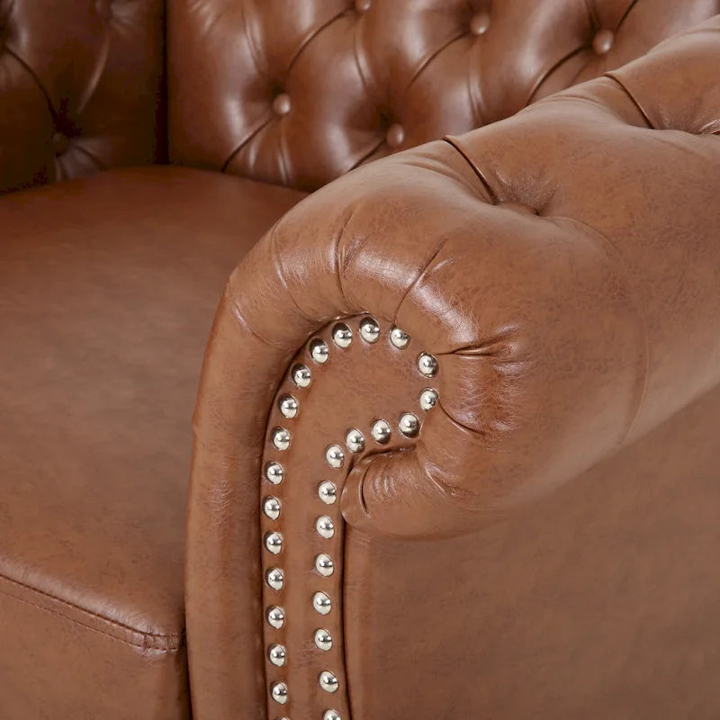 Sillón club de estilo Chesterfield con capitoné de botones, brazos enrollados y ribete de tachuelas